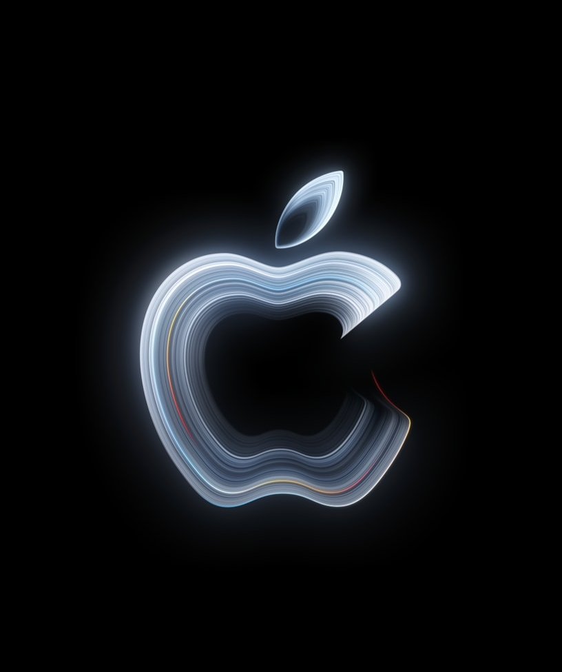 Apples bild för Pro and Tell den 28 oktober 2026: ett Apple-märke format av glödande vita och blå linjer med inslag av rött och gult, mot svart bakgrund.